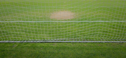 Soccer Goal Net Close-Up On Grass Pitch With Worn Goalmouth And White Line © ismailbasdas