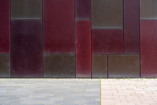 Minimal urban wall panels facade with rich texture pattern above pavement in an empty composition providing versatile copyspace for modern design use