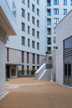 Modern urban courtyard with building architecture stairs and walkway in daylight presenting an empty calm setting and practical copyspace for real estate