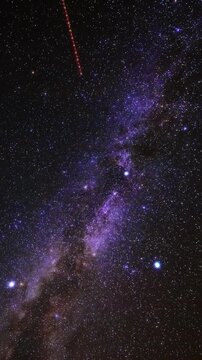 Constellations, stars, Milky Way with airplane and satellite trails. Time-lapse video.