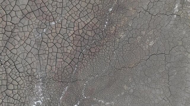 Aerial view of the intricate patterns of cracked dry earth and mineral deposits in the mining landscape of Minas de Riotinto, Andalusia, Spain.