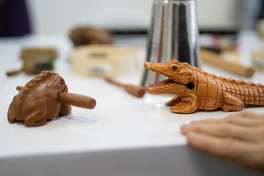 Wooden animal-shaped percussion instruments on a white surface