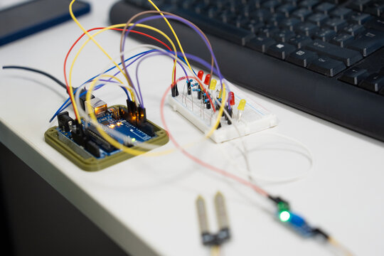 Arduino microcontroller connected to a breadboard with LEDs and sensors