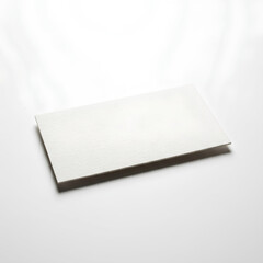 Naklejka premium White rectangular paper sheet on a white surface with shadows.