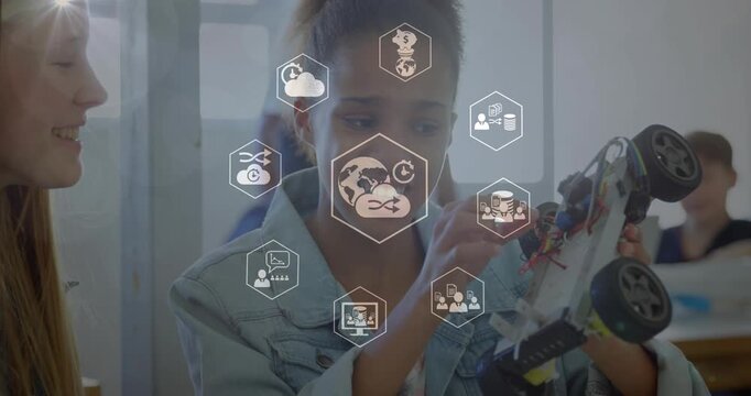 Animation of digital icons spinning over two diverse girls discussing over a car model at school