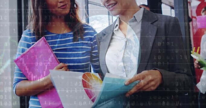 Vertical video: Woman flipping binder starting globe binary overlay while team reviewing tech file