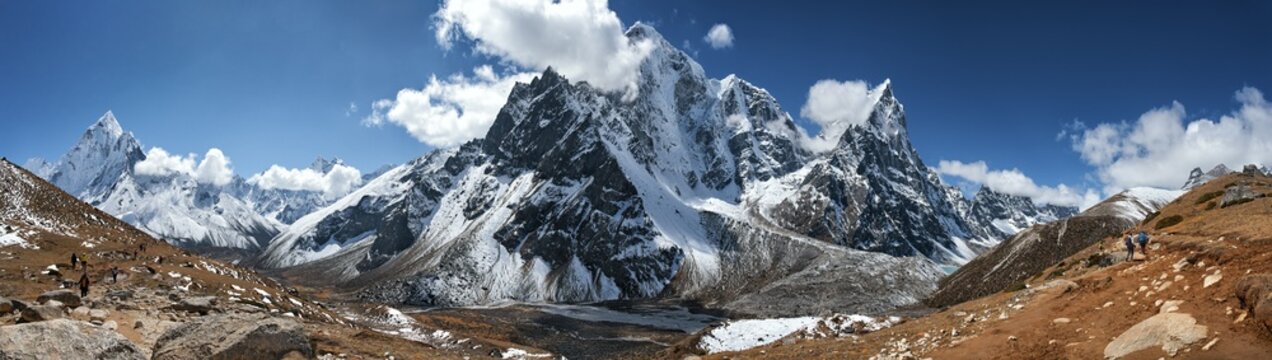 Vast Panoramic View of Snowy Himalayan Range with Adventurous Trekkers on Trail Mount Everest Base Camp, Nepal. Beautiful inspirational panoraic landscape, trekking and activity.