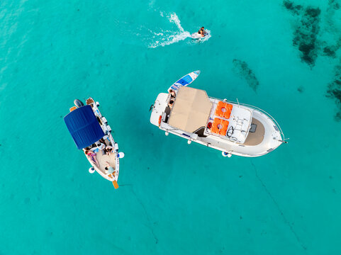 Aerial view of boats floating on the turquoise, transparent waters of the Blue Lagoon, Comino, Malta.