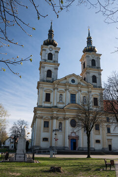Basilica of the Seven Sorrows of the Blessed Virgin Mary with twin towers and ornate facade featuring religious statues and a bright blue entrance door under a clear sky, Sastin-Straze, Slovakia