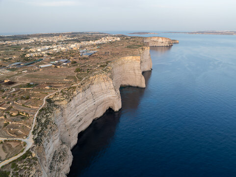 Aerial view of the rugged Sanap Cliffs standing tall against the deep blue sea, a coastal panorama of natural beauty, Munxar, Gozo, Malta.