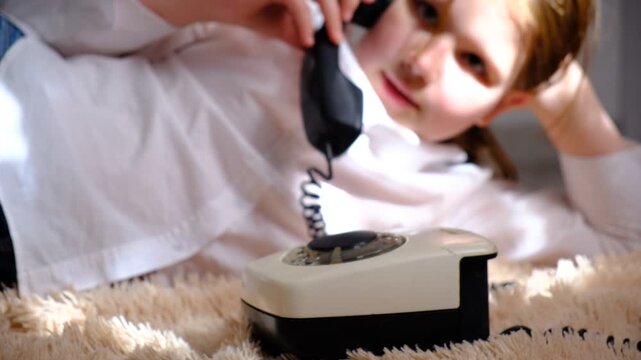 Soft blurred, Ambiance sunlight, Teenager girl with a vintage rotary phone. Pretty teenager girl talking to someone on the phone.	
