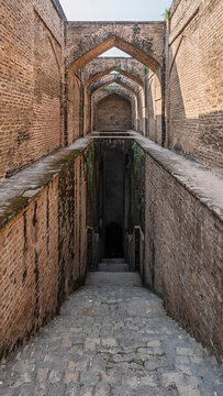 Vertical view of ancient brick baoli or step well at UNESCO World Heritage medieval Rohtas fort, Jhelum, Punjab, Pakistan