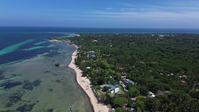 Wide aerial view of Bantayan Island showing an expansive tropical coastline with beaches greenery and surrounding ocean creating a scenic island landscape in the Philippines Southeast Asia