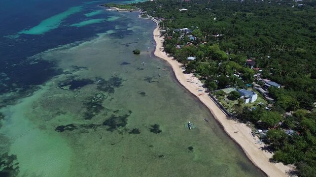 Wide aerial view of Bantayan Island showing an expansive tropical coastline with beaches greenery and surrounding ocean creating a scenic island landscape in the Philippines Southeast Asia