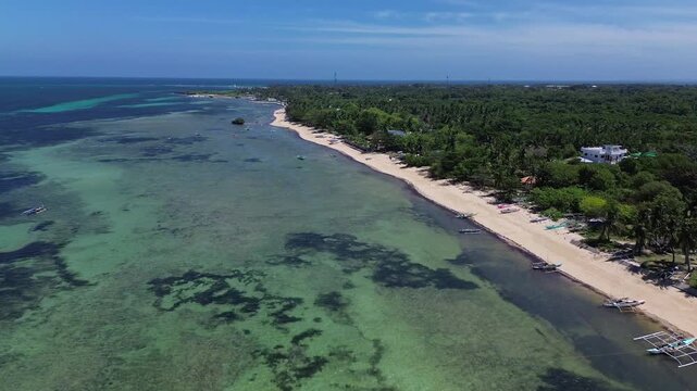 Wide aerial view of Bantayan Island showing an expansive tropical coastline with beaches greenery and surrounding ocean creating a scenic island landscape in the Philippines Southeast Asia