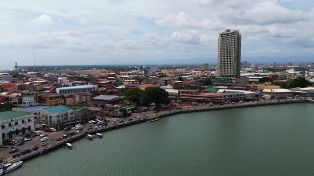Wide aerial cityscape of Iloilo City featuring modern skyscrapers and the Iloilo River. Capturing the urban growth and scenic riverfront of the City of Love on Panay Island.