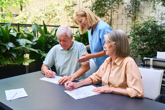 Senior people engaging in activities with support in a rehabilitation facility