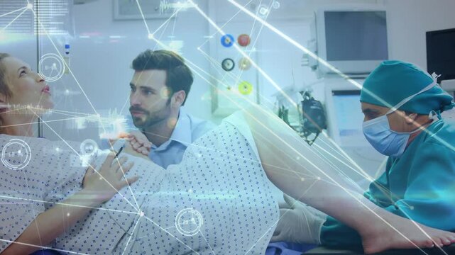 Laboring patient pushing from contraction in hospital partner holding doctor assisting with HUD