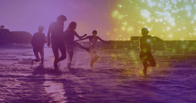 Five women splashing shore, sunset inspiring play, purple gold sparkles accenting lifestyle shots