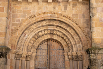 Fototapeta premium Intricate stone archway with wooden doors.. Ávila, Spain