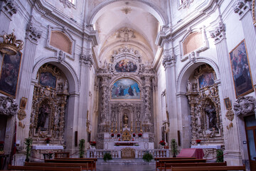 Fototapeta premium The monumental baroque facade of the Chiesa di Santa Teresa&nbsp;in Lecce, southern Italy, characterized by tall fluted columns, intricate stone carvings, and a richly dec