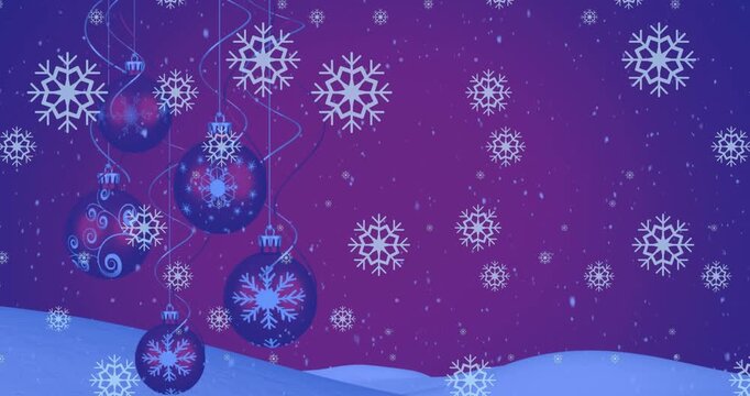 Animation of snow falling over christmas baubles decoration and winter scenery