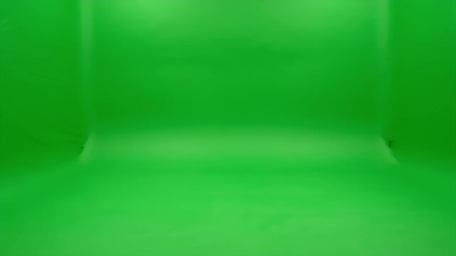 A brightly lit, empty room entirely covered in a vibrant green chroma key screen, ready for visual effects and compositing.