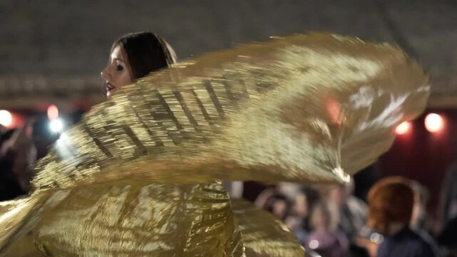 Arab dancer performs belly dance on stage. Black background. Slow motion