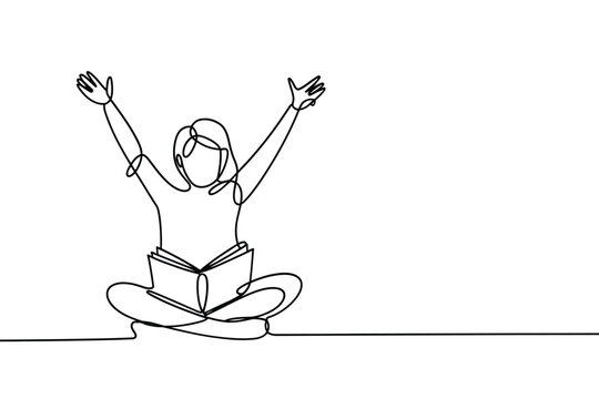 A young woman sits and reads with arms raised in joyful expression