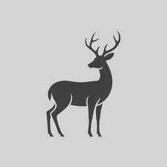 Fototapeta premium Dark silhouette of a stag with prominent antlers on a light grey backdrop