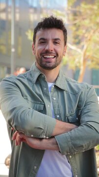 A friendly and approachable man stands confidently with crossed arms, radiating warmth and positivity. His smile conveys assurance and openness, making him relatable and trustworthy in any