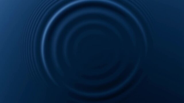 Concentric blue ripples expand across a dark, liquid surface. The smooth, rhythmic waves emanate from a central point, creating a calming and hypnotic visual effect of pure motion.