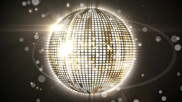 Animation of glowing spots of light over shiny golden disco ball spinning against black background