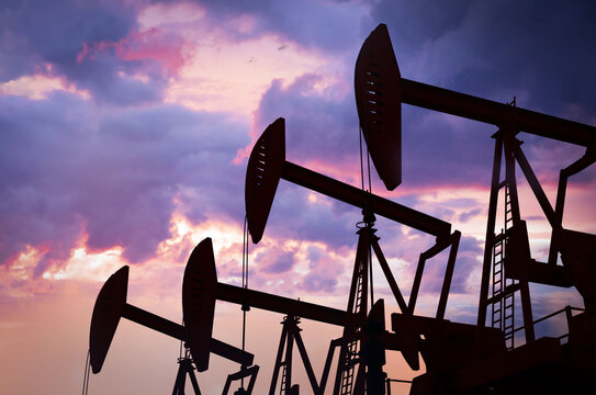 Oil and Energy Industry. Field of oil pumps at sunset, 3d animation