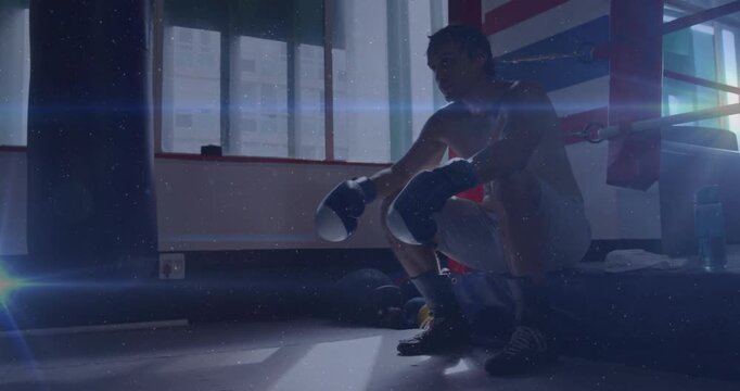 Bell signaling rest sports boxer sitting on ring resting preparing next round light beams on gloves