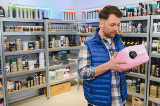 Customer choosing automotive supplies in car chemical store
