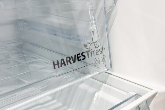 Transparent crisper compartment with empty interior inside clean refrigerator