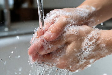 Fototapeta premium Hands Washing with Soap Under Running Water