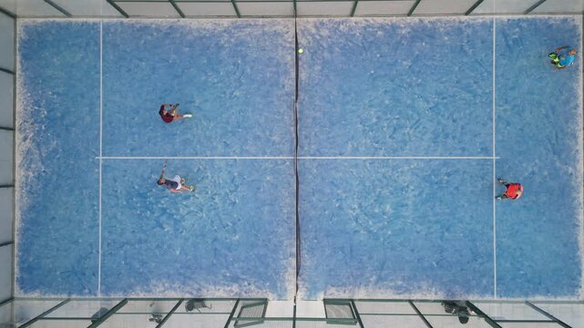 Aerial drone view of people playing padel tennis on outdoor court
