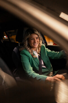Businesswoman driving car at night commuting home