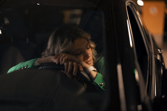 Woman resting in car after long commute