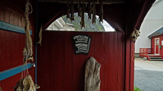 Covered walkway with dried fish in Lofoten fishing village, Norway. Traditional stockfish racks and Scandinavian coastal heritage.