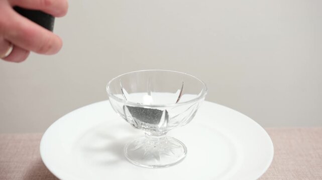 Omega-3, healthy fats, luxury seafood indulgence black caviar served with teaspoon from glass dish. Gourmet treat, nutrition-rich, elegant home presentation.