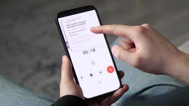 Customer Calling Marketplace Returns for Electronics Refund. Man calling customer support to return defective headphones. A Return Request Submitted notification appears on the smartphone screen. 