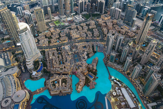 Aerial view of Dubai downtown skyline with turquoise canal and modern skyscrapers