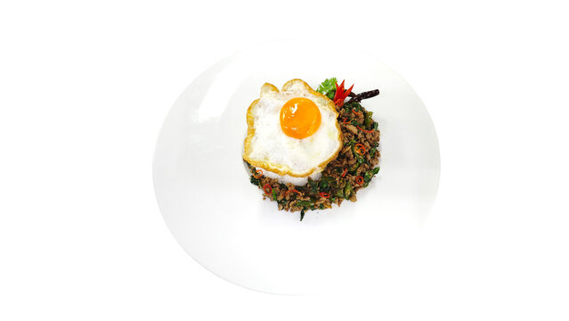 Top view of Pad Kra Pao, Thai stir-fried minced beef with holy basil and fried egg isolated on transparent background.