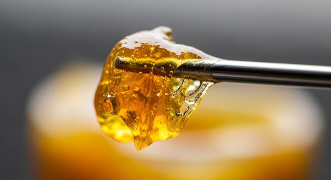 Cannabis Concentrate - A Close-Up View of Golden Resin.