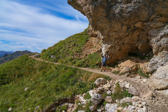 Hiker on a hike around the Langkofel mountain massif in the Dolomites. Italy.