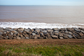 Two oystercatchers on granite boulder sea defences on the East Yorkshire North Sea Coast, UK, one of the fastest eroding coastlines in Europe © Lee Karen Stow