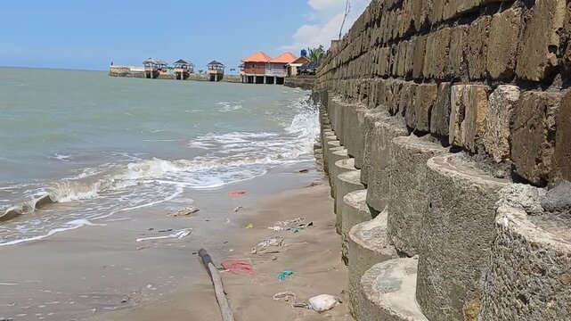 Coastal erosion protection with concrete barriers and gentle waves on the shore
